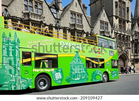 Oxford, United Kingdom - June 17, 2014 - Green open topped Oxford tour bus along High Street, Oxford, Oxfordshire, England, UK, Western Europe, June 17, 2014.