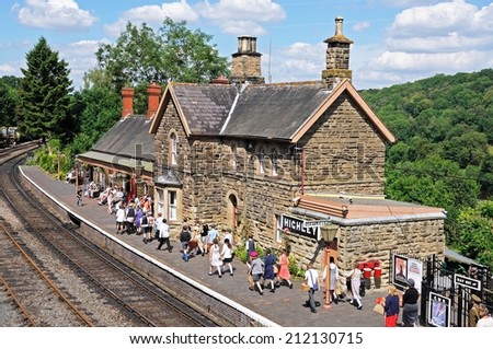 Highley, UK - July 10, 2014 - Railway platform and station building with a party of school children re-enacting World War II evacuees, Severn Valley Railway, Highley, England, UK, July 10, 2014.