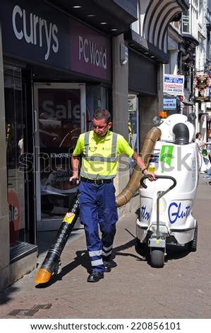 CHESTER, UNITED KINGDOM - JULY 22, 2014 - Street cleaner along Eastgate Street, Chester, Cheshire, England, UK, Western Europe, July 22, 2014.