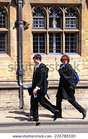 OXFORD, UNITED KINGDOM - JUNE 17, 2014 - Students walking along the High Street wearing academic dress, Oxford, Oxfordshire, England, UK, Western Europe, June 17, 2014.