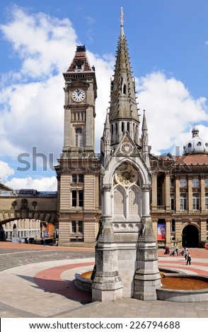 BIRMINGHAM, UK - MAY 14, 2014 - Chamberlain memorial in Chamberlain Square with the clock tower of Birmingham museum and art gallery to the rear, Birmingham, West Midlands, England, UK, May 14, 2014.