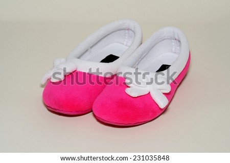 A pair of Ladies pink slippers with white trim.