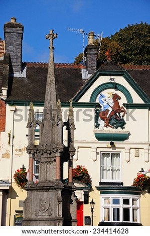 ASHBOURNE, UK - SEPTEMBER 7, 2014 - The market cross to commemorate Francis Wright with the George and Dragon pub to the rear in the Market Place, Ashbourne, Derbyshire, England, UK, September 7, 2014