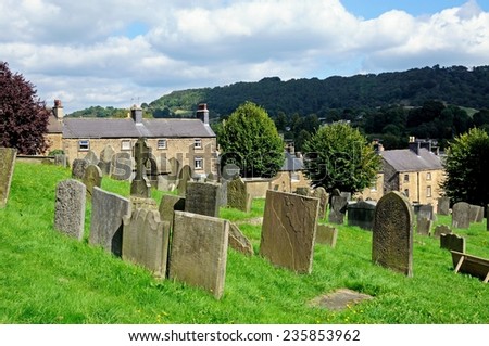 BAKEWELL, UNITED KINGDOM - SEPTEMBER 7, 2014 - All Saints Parish Church graveyard with cottages to the rear, Bakewell, Derbyshire, England, UK, Western Europe, September 7, 2014.