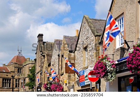 BAKEWELL, UNITED KINGDOM - SEPTEMBER 7, 2014 - Row of British flags on shop walls in the town centre, Bakewell, Derbyshire, England, UK, Western Europe, September 7, 2014.