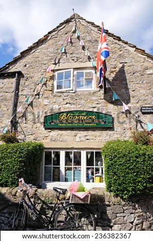 BAKEWELL, UK - SEPTEMBER 7, 2014 - Bloomers Original Bakewell Pudding factory and shop with a bicycle in the foreground, Bakewell, Derbyshire, England, UK, Western Europe, September 7, 2014.