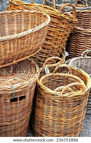 Traditional wicker baskets for sale outside a shop along the High Street, Burford, Oxfordshire, England, UK, Western Europe.
