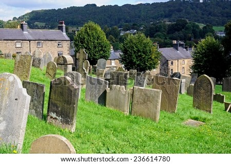 BAKEWELL, UNITED KINGDOM - SEPTEMBER 7, 2014 - All Saints Parish Church graveyard with cottages to the rear, Bakewell, Derbyshire, England, UK, Western Europe, September 7, 2014.