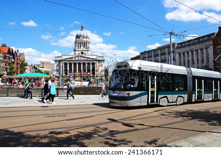 NOTTINGHAM, UK - JULY 17, 2014 - Modern tram passing the Council House also known as the city hall in the Old Market Square, Nottingham, Nottinghamshire, England, UK, Western Europe, July 17, 2014.