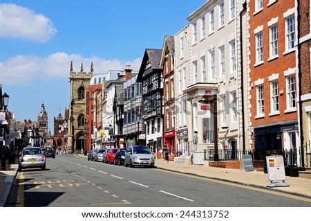 CHESTER, UK - JULY 22, 2014 - Buildings and shops along Bridge Street with St Peters church and St Michaels church to the rear, Chester, Cheshire, England, UK, Western Europe, July 22, 2014.