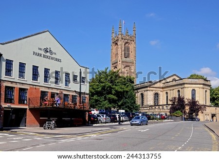 DERBY, UNITED KINGDOM - JULY 17, 2014 - The Cathedral of All Saints with a bike shop and cafe to the left hand side, Derby, Derbyshire, England, UK, Western Europe, July 17, 2014.