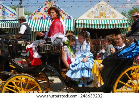 SEVILLE, SPAIN - APRIL 12, 2008 - Spanish family in traditional dress travelling in a horse drawn carriage at the Seville Fair, Seville, Andalusia, Spain, Western Europe, April 12, 2008.
