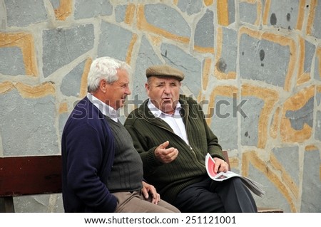 CASARES, SPAIN - MARCH 16, 2011 - Two old Spanish men sitting on a bench chatting, Casares, Cadiz Province, Costa del Sol, Malaga Province, Andalusia, Spain, Western Europe, March 16, 2011.