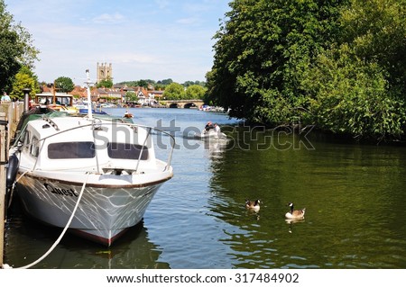 HENLEY-ON-THAMES, UK - JULY 10, 2015 - Boats on the River Thames with the church to the rear, Henley-on-Thames, Oxfordshire, England, UK, Western Europe, July 10, 2015.