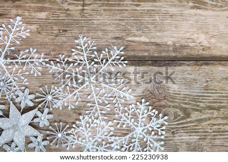 Snowflakes border on grunge wooden background. Winter holidays concept.