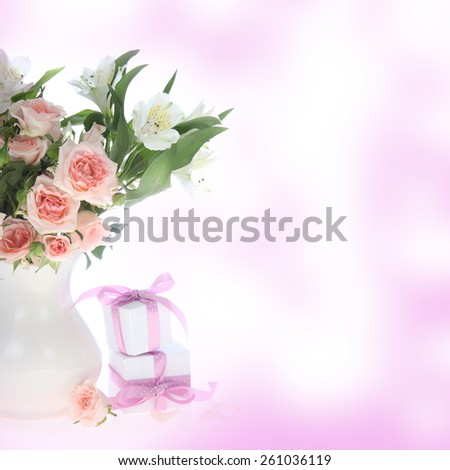 Bouquet of flowers  in a vase and gifts on an abstract background