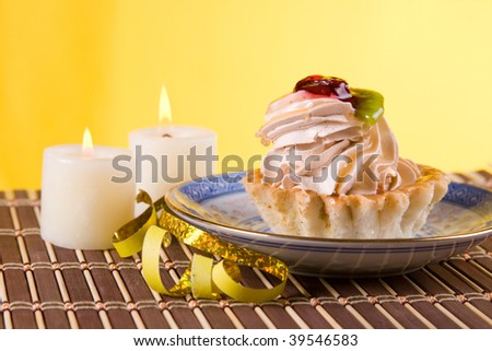 Cake and candles on a yellow background