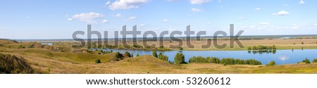 Panoramic photo of the river. Beautiful summer landscape with river and field.
