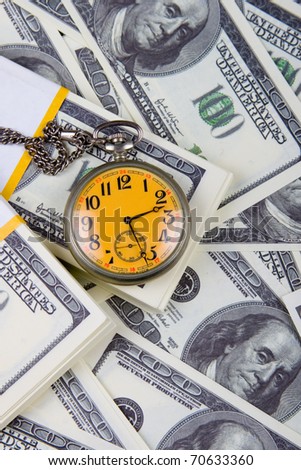 Pocket watch on a stack of dollars, reflecting time and money