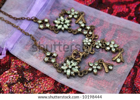 Green gemstone necklace on a small organza bag