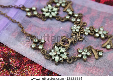 Green gemstone necklace on a small organza bag