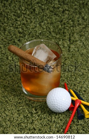 Golf ball, pegs and a drink with a cigar