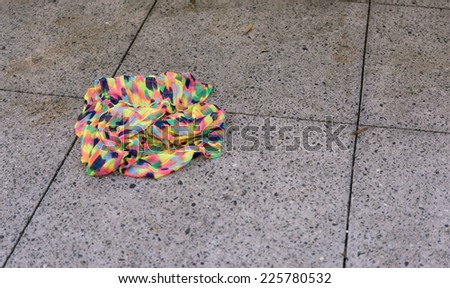 Colorful Scarf Abandoned on Street Sidewalk