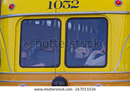 People Riding in the Back of a City Bus