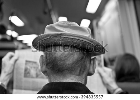 Older Man Reading Newspaper on Commuter Train Black and White