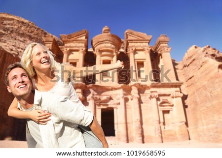 Jordan travel couple tourists happy at The Monastery, Petra\'s largest monument, in Jordan.