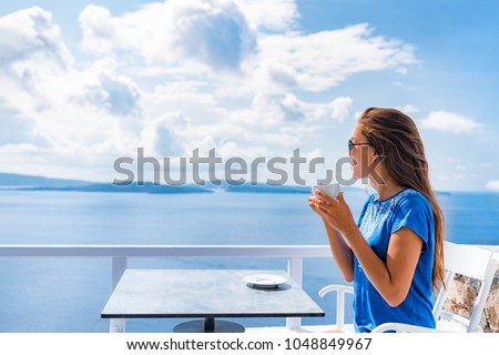 Tranquil morning serene woman relaxing drinking breakfast coffee enjoying ocean sea view on luxury hotel balcony, summer travel holidays. Home living.