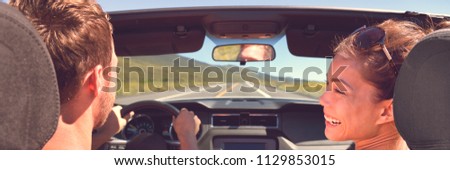 Road trip vacation couple driving convertible car on summer travel holiday fun. Laughing Asian girl with man driver. Banner panorama.