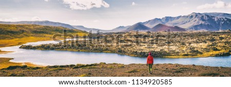 Hiking nature amazing landscape travel wanderlust woman hiker on holiday in Iceland. Panoramic banner hero view of icelandic lake.
