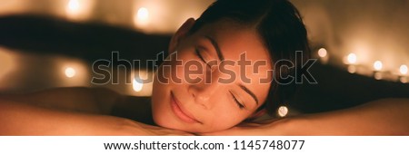 Luxury spa massage woman. Pampering whirlpool jacuzzi lifestyle girl relaxing in hot water banner panorama.