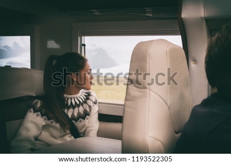 RV camper van travel Asian girl sitting in back of motorhome car on Iceland road trip. Europe vacation lifestyle.