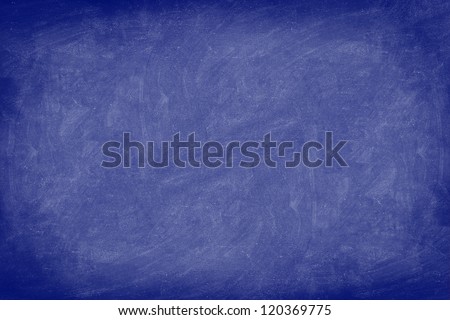 Chalkboard / dark blue blackboard texture background. Used feel, textured with chalk traces. Photo.