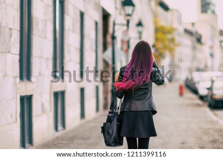 Colored hair style woman walking from behind with long brown ombre dyed hair. Fashion urban young people hair salon coloring dyeing treatment.