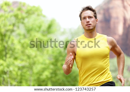 Sport - Runner. Man Running With Concentration, Determination And Strength Towards Goals And Success In Marathon. Fit Male Sport Fitness Model Sprinting Outdoors.
