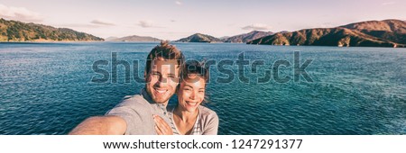 Cruise ship holiday travel vacation tourists taking selfie on summer holidays destination banner panorama .Interracial couple Asian woman tourist, Caucasian man smiling.