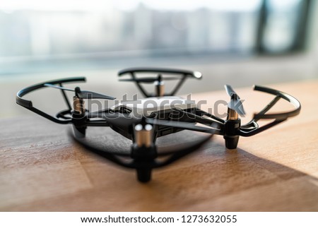 Small drone toy for kids play indoors. Miniature drone technology with camera to fly inside home. Fun gadget lifestyle.
