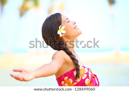 Freedom beach woman smiling happy and serene with arms outstretched in free pose Beautiful spiritual elated happiness concept image with multicultural Asian Caucasian female model Freedom beach woman smiling happy and serene with arms outstretched in free pose Beautiful spiritual elated happiness concept image with multicultural Asian Caucasian female model