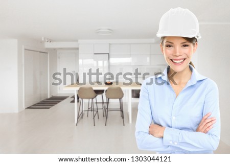 Home architect business woman house inspection of new condo project building inspecting remodeled modern kitchen. Happy Asian architect professional with hard hat helmet.