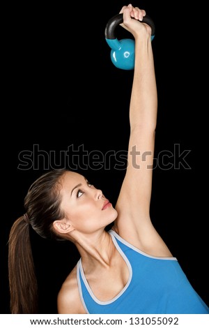 Fitness woman training with kettlebell Fit beautiful multicultural fitness instructor isolated on black background Fitness woman training with kettlebell Fit beautiful multicultural fitness instructor isolated on black background