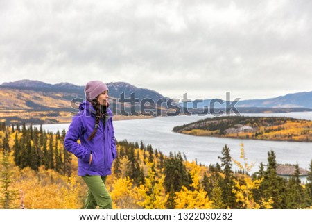 Hike nature outdoors Asian hiker woman relaxing walking happy in mountains of Alaska landscape background. USA travel in autumn.