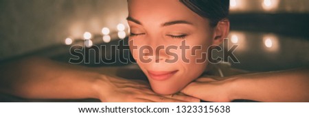 Luxury spa massage woman. Pampering in jacuzzi lifestyle girl relaxing in hot water banner panorama.