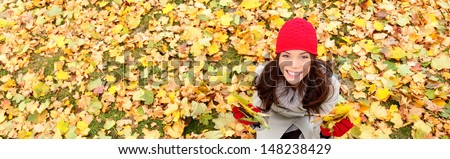 Autumn / Fall Banner Background Texture Of Leaves With Happy Woman. Panoramic Fall Concept Portrait Of Smiling Excited Girl Sitting On Colorful Autumn Leaves Outdoor In Forest. Mixed Race Asian Girl.
