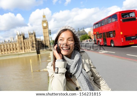 London - Professional Business Woman On Smartphone Smiling Happy. Young Happy Casual Woman Talking On Smart Phone Walking Outdoor In Fall Or Winter On Westminster Bridge, London, England. Asian Model.