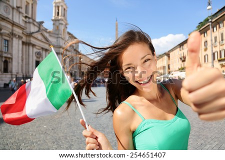 Italian flag happy tourist woman in Rome, Italy. Young Asian girl holding flag for holiday vacation concept or student exchange for learning the language.