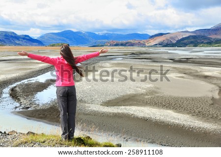 Woman enjoying view of Iceland black sand dunes in south Icelandic nature landscape. Serene person relaxing soaking in the natural beauty. Tourist visiting landmarks tourists attractions.