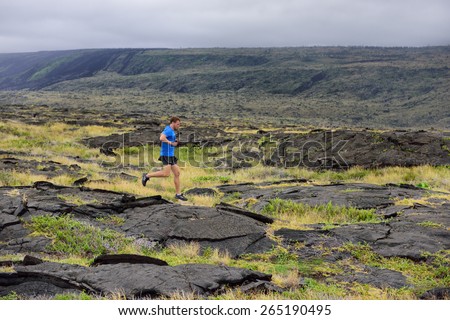 Runner. Sport running man in cross country trail run. Male athlete exercising and training outdoors in beautiful mountain nature landscape.